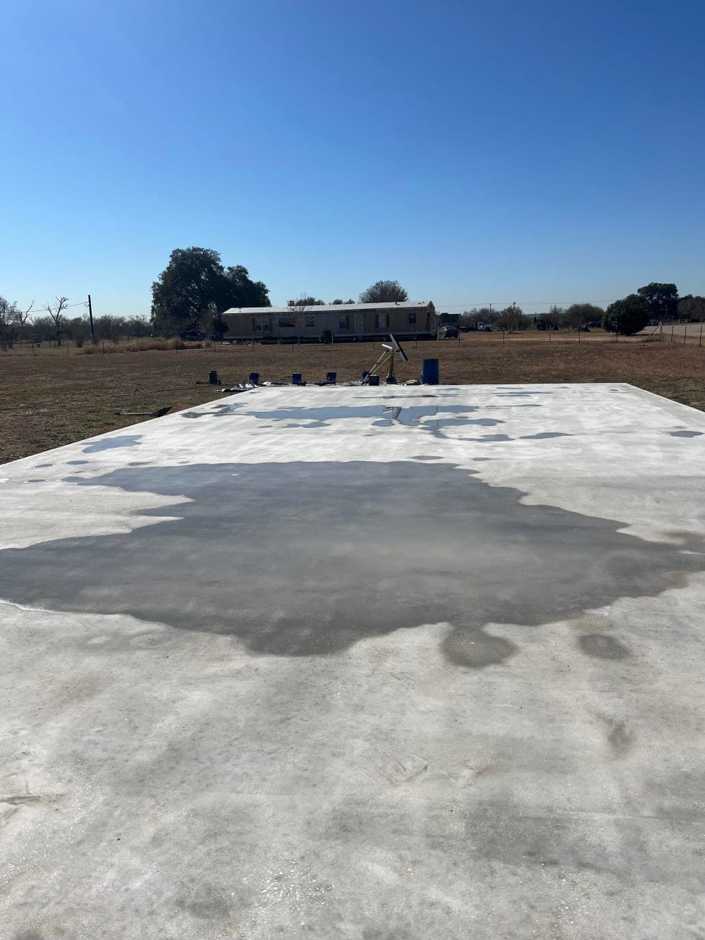 Primed blank concrete slab before pickleball court surfacing near San Antonio, Texas