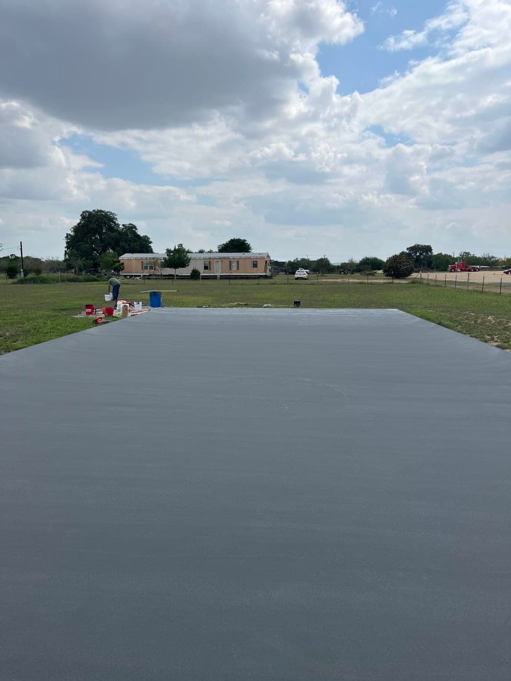 Gray acrylic base coat applied to the pickleball court near San Antonio, Texas