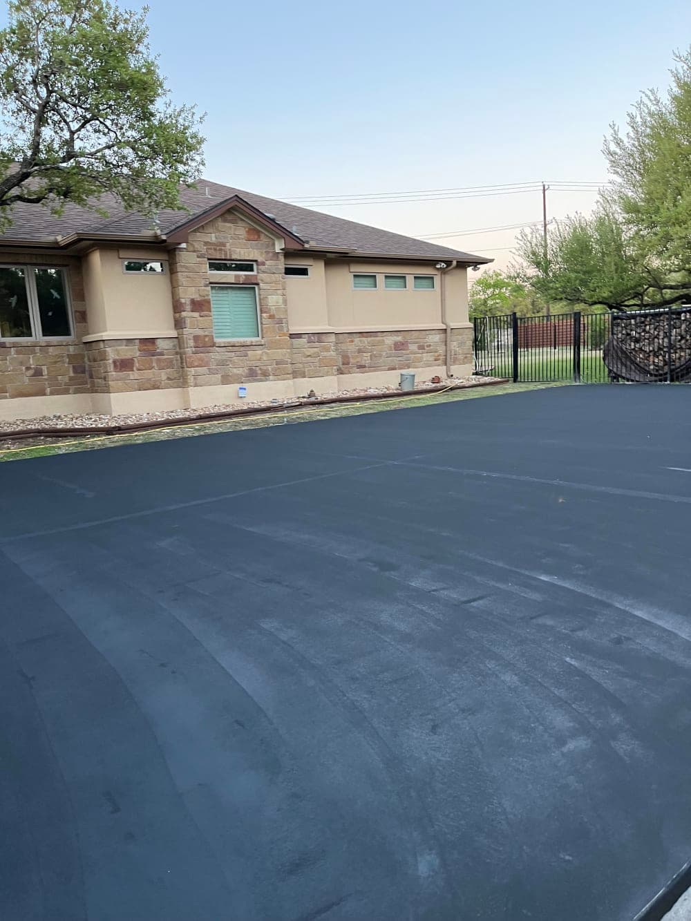 Black acrylic base coat applied over the prepped slab in Georgetown, Texas