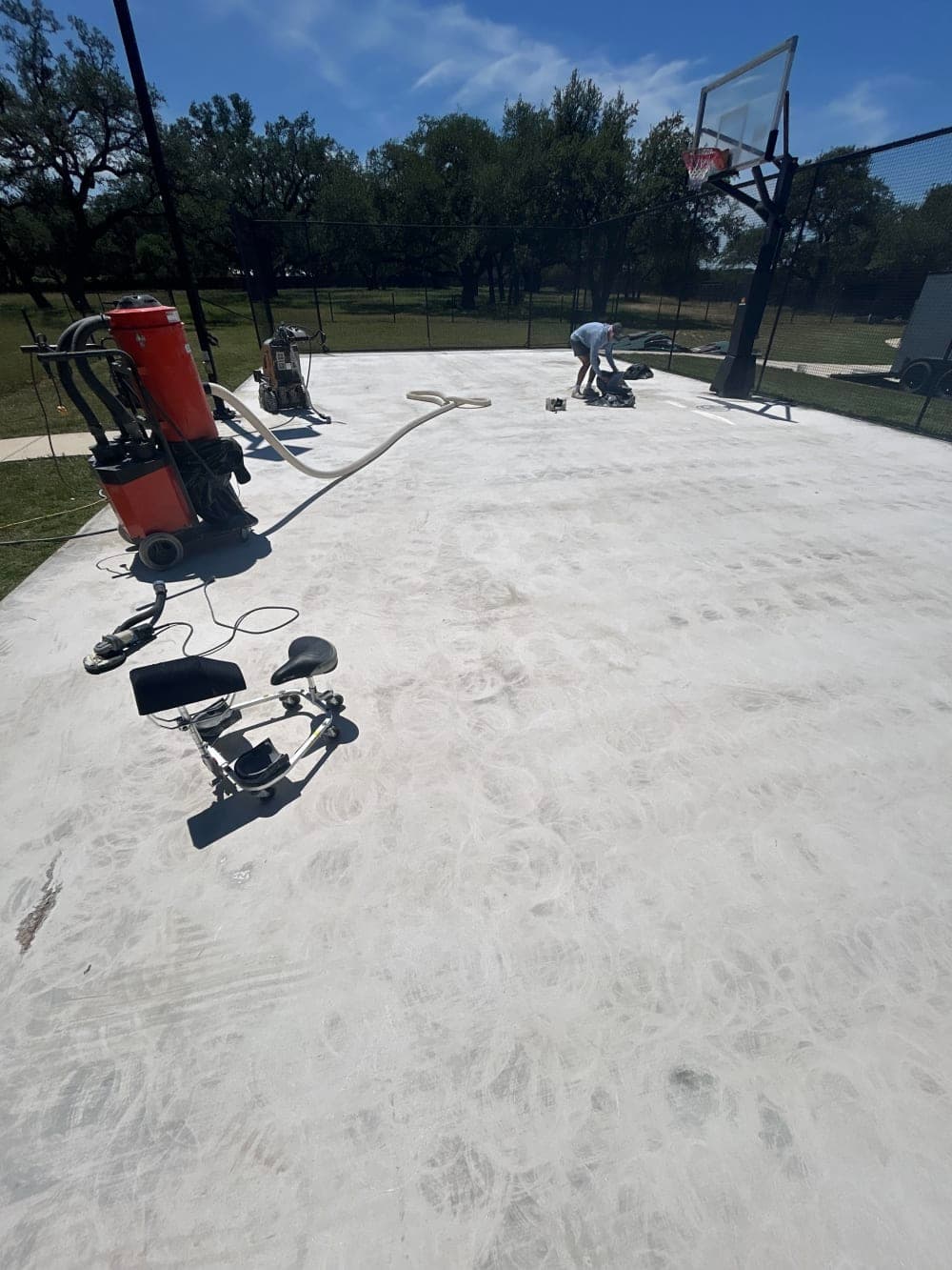 Grinding off the old failing surface down to the concrete before resurfacing in Wimberley, Texas