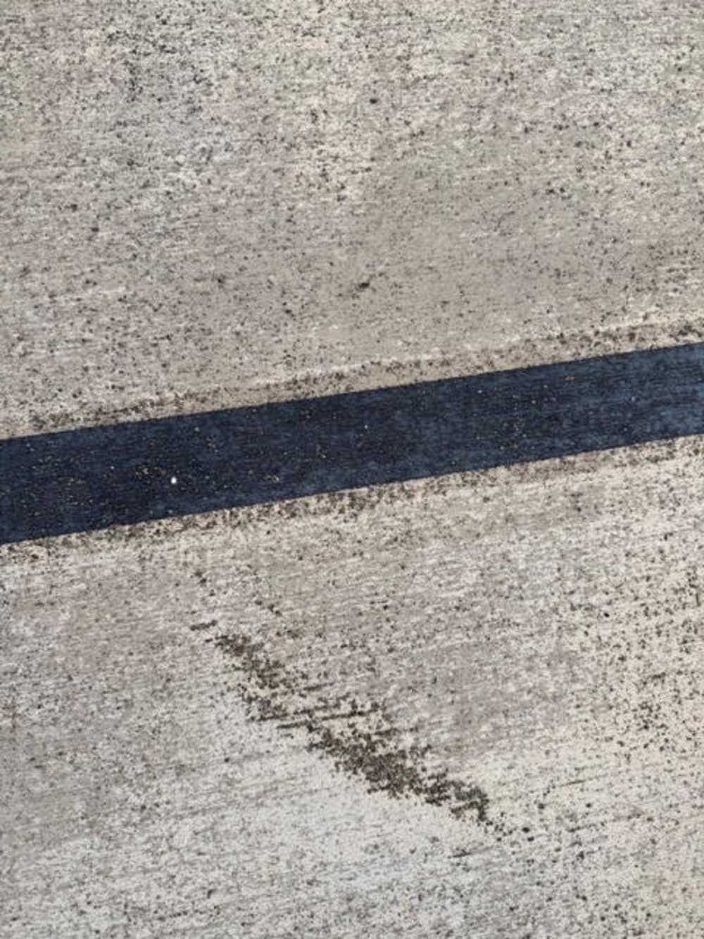 Close-up of a painted line on rough bare concrete before surfacing in Sumner, Washington