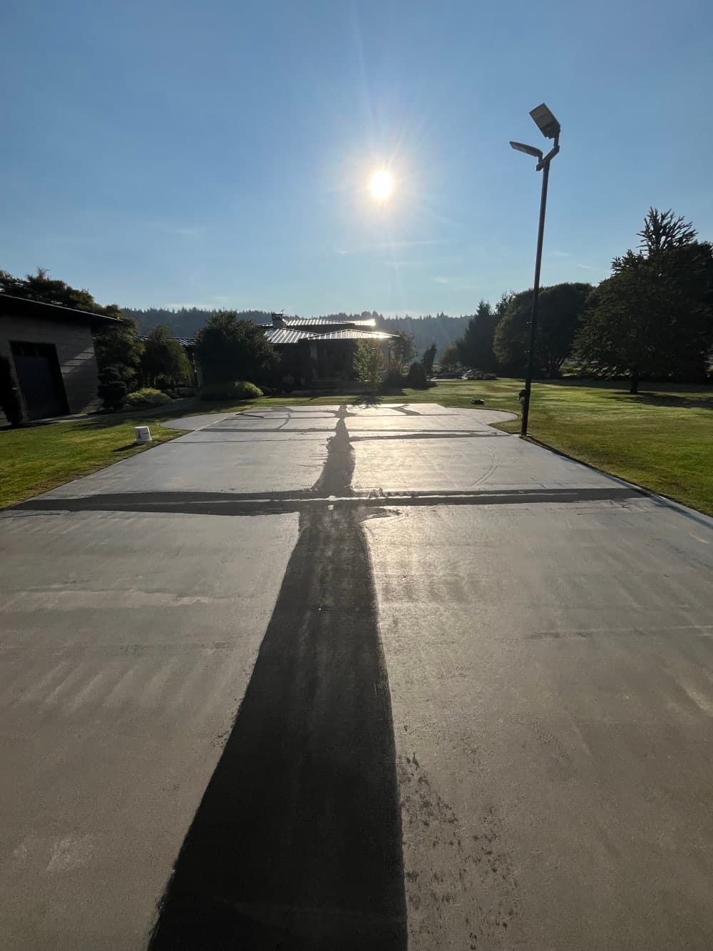 Old painted lines and slab joints filled and patched before the base coat in Sumner, Washington