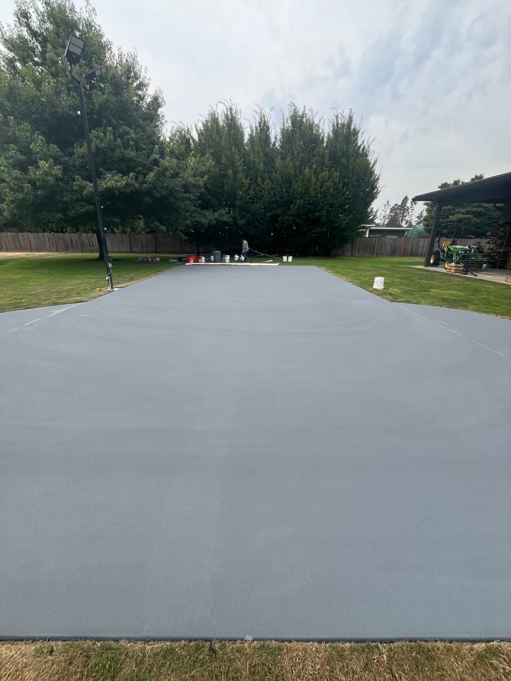 Gray acrylic color coat applied over the full pickleball court in Sumner, Washington